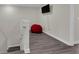 Cozy bonus room with neutral walls, wood flooring, and a comfortable red beanbag chair at 11526 Comic Aly, Orlando, FL 32832
