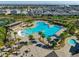 Stunning aerial view of the community pool, including a splash pad, tables, and a hot tub at 11526 Comic Aly, Orlando, FL 32832