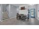 The dining area features stairs nearby and a vibrant blue door for added charm and personality at 11526 Comic Aly, Orlando, FL 32832