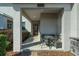 Welcoming front porch featuring an outdoor seating area, stone accents, and a well-kept garden space at 11526 Comic Aly, Orlando, FL 32832