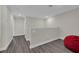 Upstairs hallway with grey flooring and a door to a room at 11526 Comic Aly, Orlando, FL 32832