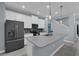 Modern kitchen featuring stainless steel appliances and an island with seating at 11526 Comic Aly, Orlando, FL 32832