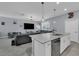 View of kitchen flowing into the living room with an island, stainless steel appliances, and modern pendant lighting at 11526 Comic Aly, Orlando, FL 32832