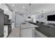 Open-concept kitchen featuring a center island, stainless steel appliances, and seamless flow into the living area at 11526 Comic Aly, Orlando, FL 32832