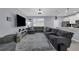Open-concept living room shows the kitchen and a large sectional couch for entertaining or relaxing at 11526 Comic Aly, Orlando, FL 32832