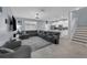 Spacious living room features an open concept with the kitchen and a staircase leading upstairs at 11526 Comic Aly, Orlando, FL 32832
