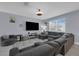 Comfortable living room area with plush seating, neutral colors, and a bright window with natural light at 11526 Comic Aly, Orlando, FL 32832