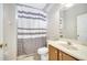 Third bathroom with shower/tub combo and wood vanity at 116 Whispering Pines Way, Davenport, FL 33837