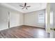 Bright bedroom with wood-look floors and ceiling fan at 116 Whispering Pines Way, Davenport, FL 33837