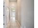 Clean and bright hallway with tile flooring at 116 Whispering Pines Way, Davenport, FL 33837