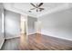 Large main bedroom with wood-look floors and ensuite bathroom at 116 Whispering Pines Way, Davenport, FL 33837