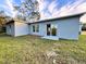 Newly built home with sliding glass doors leading to a grassy backyard at 1211 Baltic Dr Dr, Poinciana, FL 34759