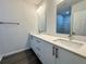 Double vanity bathroom with modern white cabinets and quartz countertops at 1211 Baltic Dr Dr, Poinciana, FL 34759