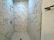 Walk-in shower with marble-look tile and built-in seat at 1211 Baltic Dr Dr, Poinciana, FL 34759