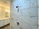 Clean shower with marble-look tile and rainfall shower head at 1211 Baltic Dr Dr, Poinciana, FL 34759