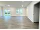 Spacious living area with gray vinyl flooring and access to the backyard at 1211 Baltic Dr Dr, Poinciana, FL 34759