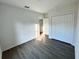 Spacious bedroom with gray vinyl plank flooring and double door closet at 1212 Baltic Dr Way, Poinciana, FL 34759