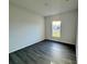 Simple bedroom with gray vinyl plank flooring and a window with natural light at 1212 Baltic Dr Way, Poinciana, FL 34759