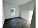 Bright bedroom with gray vinyl plank flooring and a window overlooking the outdoors at 1212 Baltic Dr Way, Poinciana, FL 34759