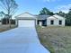 Newly built home featuring a two-car garage and spacious front yard at 1212 Baltic Dr Way, Poinciana, FL 34759