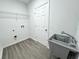 Bright laundry room featuring a utility sink and shelving at 1212 Baltic Dr Way, Poinciana, FL 34759