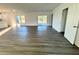 Bright living room features gray vinyl plank flooring and sliding glass doors to the backyard at 1212 Baltic Dr Way, Poinciana, FL 34759