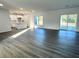 Open-concept living area with modern flooring and kitchen access at 1212 Baltic Dr Way, Poinciana, FL 34759