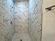 Walk-in shower with marble-look tile and built in seat at 1212 Baltic Dr Way, Poinciana, FL 34759