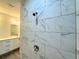 Shower with marble-look tile and dual shower heads at 1212 Baltic Dr Way, Poinciana, FL 34759