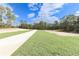 Landscaped community green space with a paved walkway at 12281 Sw 75Th St, Dunnellon, FL 34432