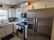 Galley style kitchen with stainless steel appliances and white cabinets at 1238 Conch Key Ln, Davenport, FL 33837