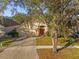 One-story house with a driveway and a large tree in the front at 13013 Quail Ct, Orlando, FL 32828