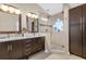 Elegant bathroom with double sinks, large shower, and dark wood cabinets at 13013 Quail Ct, Orlando, FL 32828