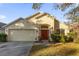 Beautiful one-story home with a two-car garage and well-manicured lawn at 13013 Quail Ct, Orlando, FL 32828