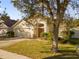 Landscaped yard and inviting front entrance of a one-story house at 13013 Quail Ct, Orlando, FL 32828