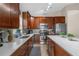 Spacious kitchen featuring L-shaped counters, ample cabinetry, and a stylish backsplash at 13013 Quail Ct, Orlando, FL 32828