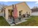 Spacious patio with seating area, umbrella, and grill at 13013 Quail Ct, Orlando, FL 32828