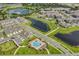 Aerial view of a community with houses, lakes, and a pool at 13715 Bressler Aly, Windermere, FL 34786