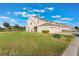 Tan house with a screened porch, green lawn, and paved driveway at 13715 Bressler Aly, Windermere, FL 34786