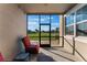 Bright screened porch with a red recliner chair, great for relaxing at 13715 Bressler Aly, Windermere, FL 34786