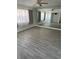 Spacious living room with large mirror and light grey tile floors at 1414 Rolling Green Dr, Apopka, FL 32703