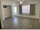 Bright and airy living room with grey tile floors and neutral decor at 1414 Rolling Green Dr, Apopka, FL 32703