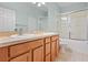 Bathroom with double sinks, light wood cabinets, and a shower/tub combo at 14624 Clarkson Dr, Orlando, FL 32828