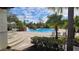 Resort-style pool with waterfall feature, surrounded by palm trees and lounge chairs at 14624 Clarkson Dr, Orlando, FL 32828