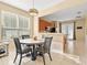 Bright dining area with a round table and chairs, adjacent to the kitchen at 14624 Clarkson Dr, Orlando, FL 32828