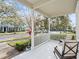 Relaxing front porch with rocking chairs, overlooking a tree-lined street at 14624 Clarkson Dr, Orlando, FL 32828