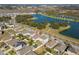 Aerial neighborhood view features homes, yards, and a nearby lake with fountain at 1470 Silverado Flats St, Kissimmee, FL 34744