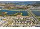 Aerial shot of homes with a lake and fountain in a suburban neighborhood at 1470 Silverado Flats St, Kissimmee, FL 34744