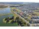 Aerial view showcasing homes, lake, highway, and community layout with green spaces at 1470 Silverado Flats St, Kissimmee, FL 34744