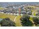 Overhead view showing a residential area with green spaces, a pond, sidewalks, and community park at 1470 Silverado Flats St, Kissimmee, FL 34744